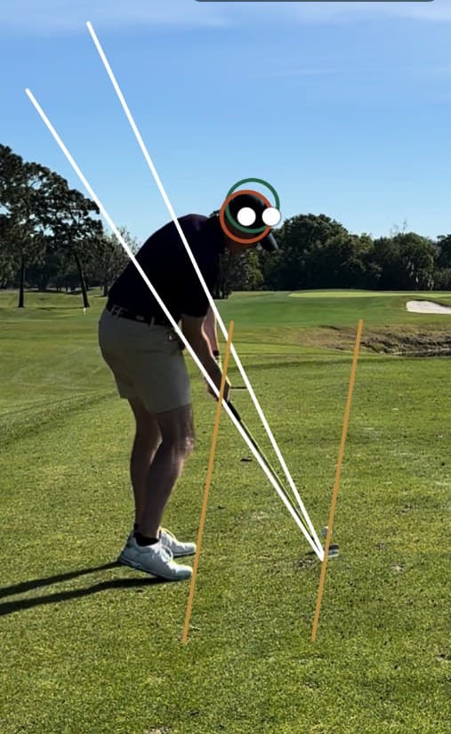 Downswing position with swing-plane lines drawn by a coach